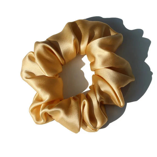 Champagne beige large mulberry silk scrunchie with a smooth, elegant texture. Premium silk hair tie for a stylish and frizz-free hair hold.