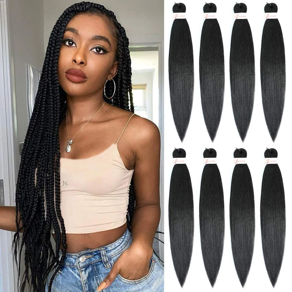 Woman with braided hair next to bundles of black hair extensions.