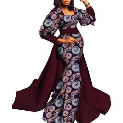 Woman wearing a long dress with a patterned design on a white background