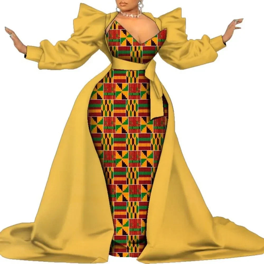 Yellow satin overlay gown with a colorful geometric print panel, puff sleeves and a long train, on a white background.
