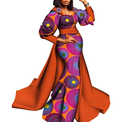 Colorful traditional outfit with long orange skirt and patterned top on a white background