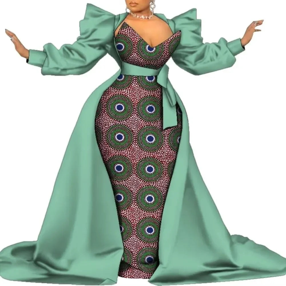 Sage green satin overlay gown with a dark geometric print panel and puff sleeves, on a white background.