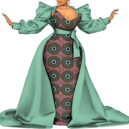 Sage green satin overlay gown with a dark geometric print panel and puff sleeves, on a white background.