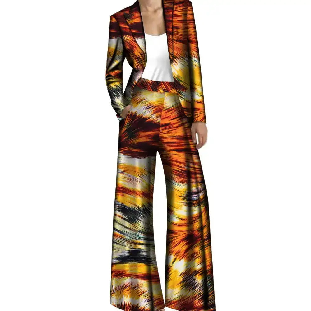 Fiery orange and yellow African pantsuit with a dynamic print, featuring a fitted jacket and wide-leg trousers. A statement-making outfit.