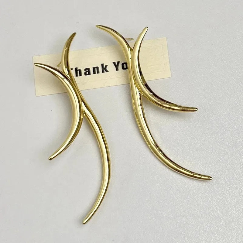 Sculptural gold antler-inspired earrings close-up