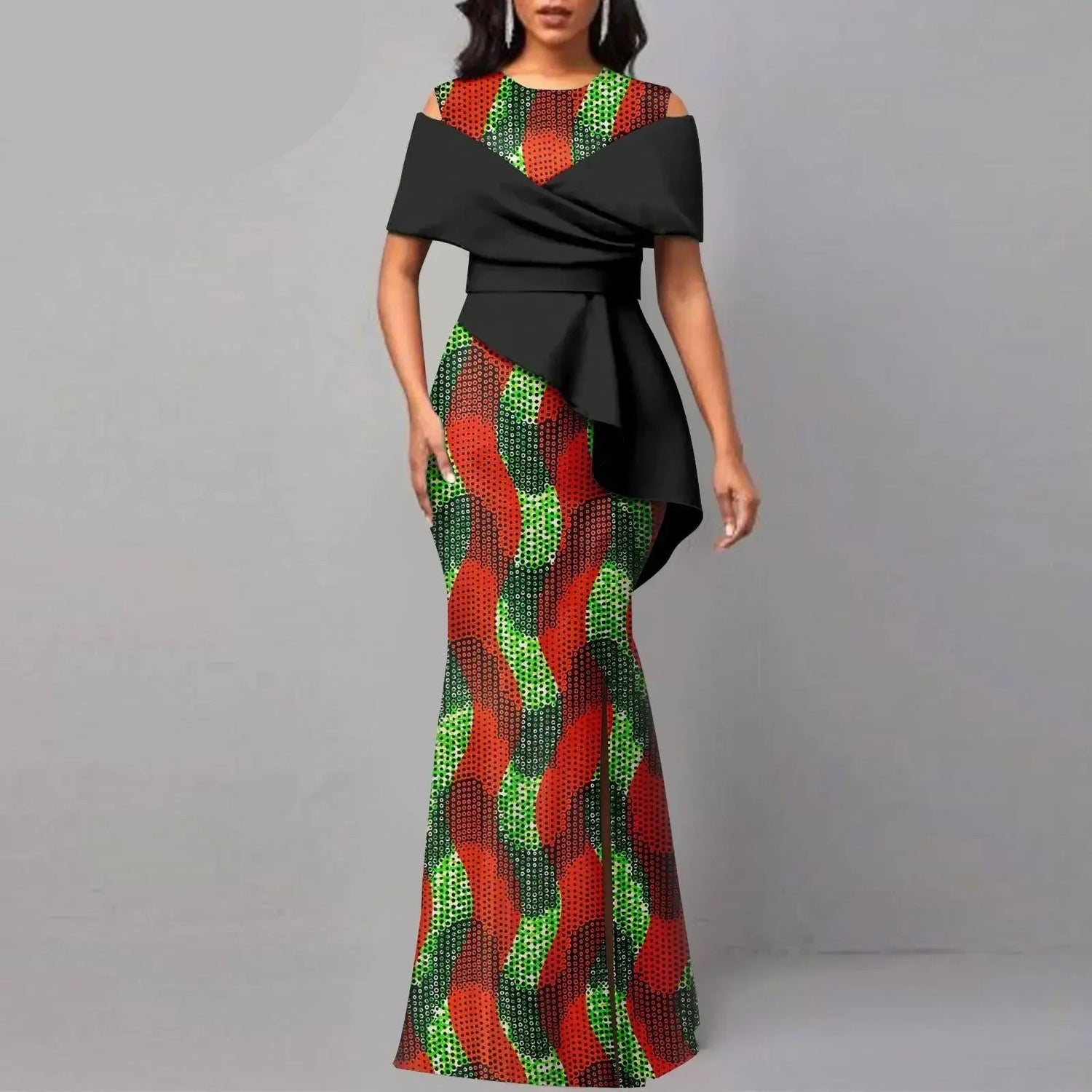 Woman wearing a colorful dress with black overlay, branded &