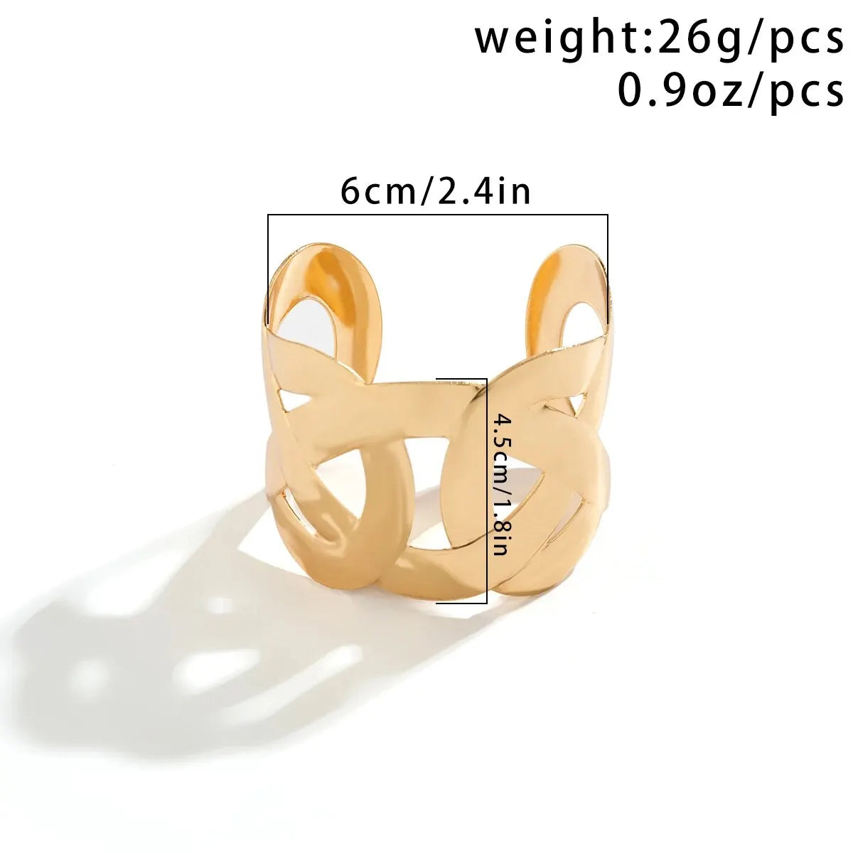 Gold open cuff with interlocking loops, labeled 6 cm (2.4 in) wide, 4.5 cm (1.8 in) tall and 26 g in weight.