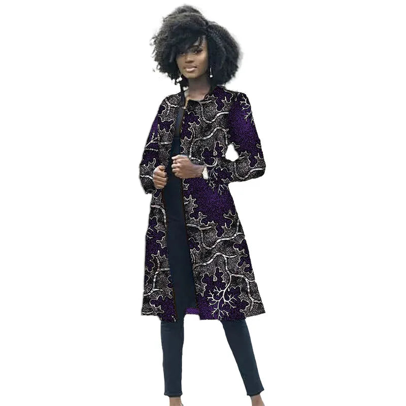 Woman wearing a long, dark patterned coat on a white background