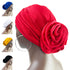 Floral stretch bandana head wrap in vibrant red with a large fabric rose detail at the back. Soft, stretchy material for a comfortable fit.