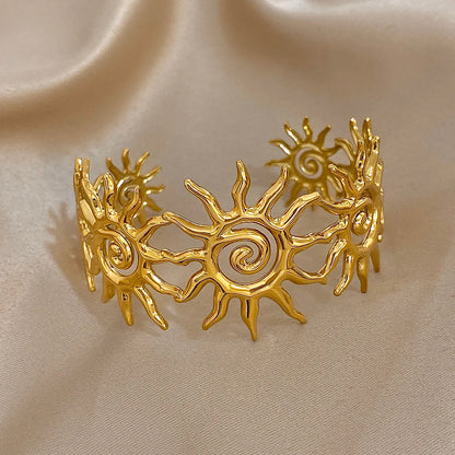 The Gold Spiral Hair Cuff on an brown background