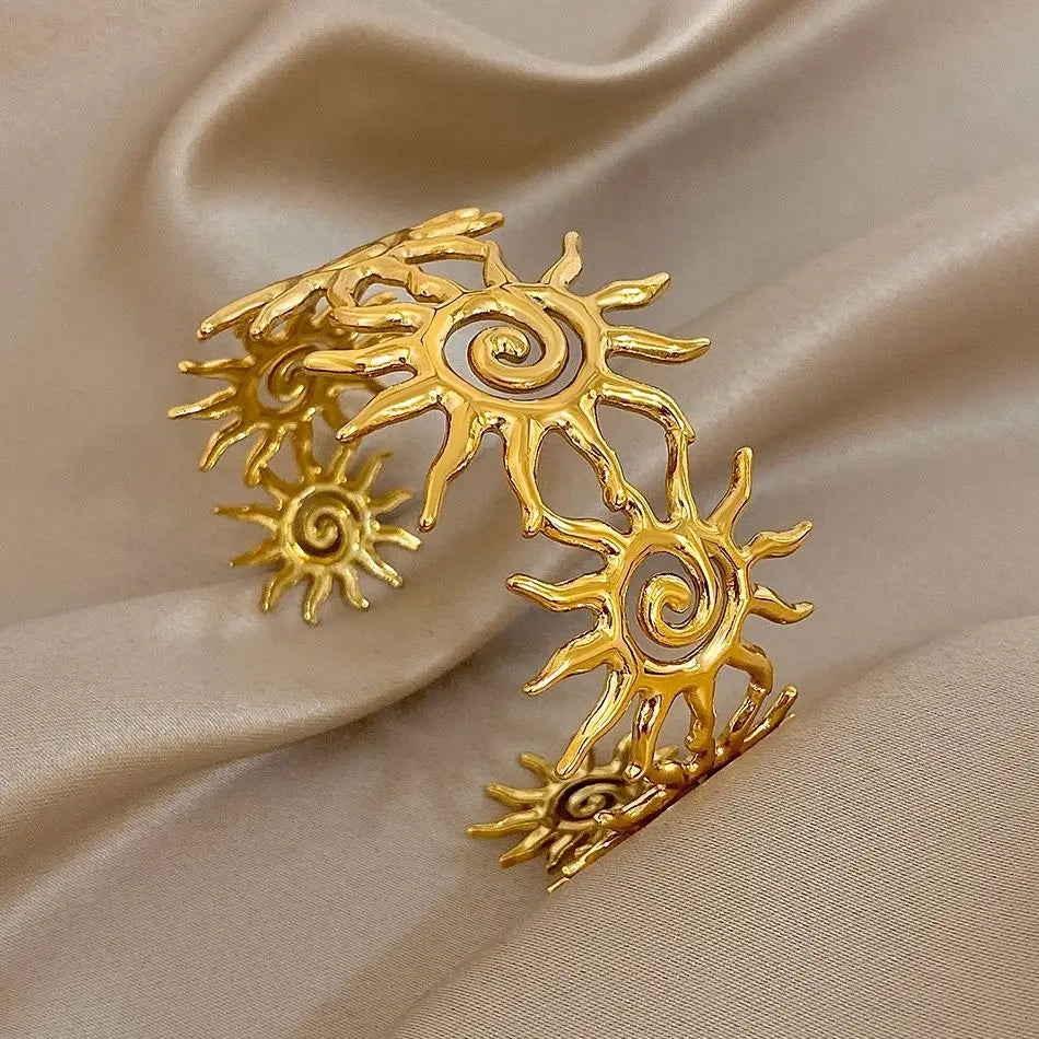 The Gold Spiral Hair Cuff and bracelet on an satin brown background