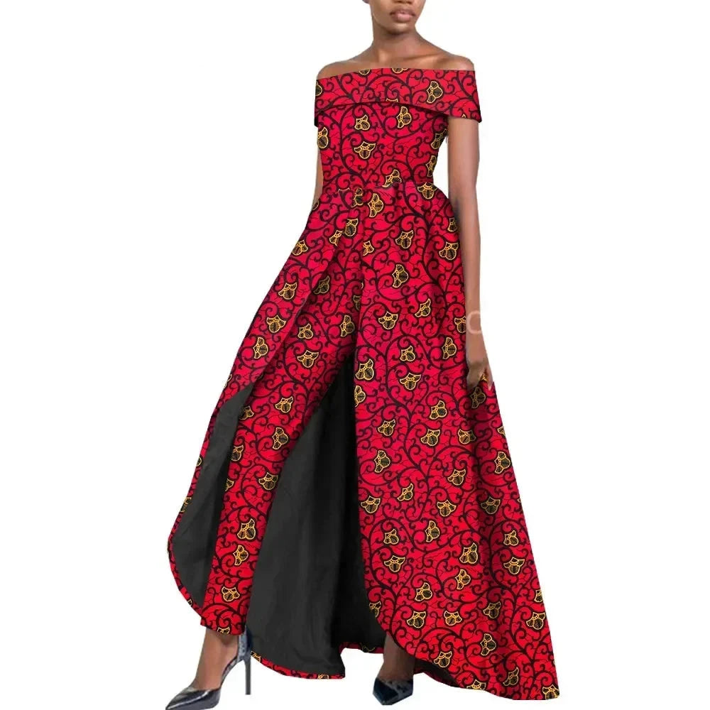 Elegant African pantsuit for women in red and black print. Off-shoulder top with a dramatic long cape, tailored for a custom fit in 100% cotton.