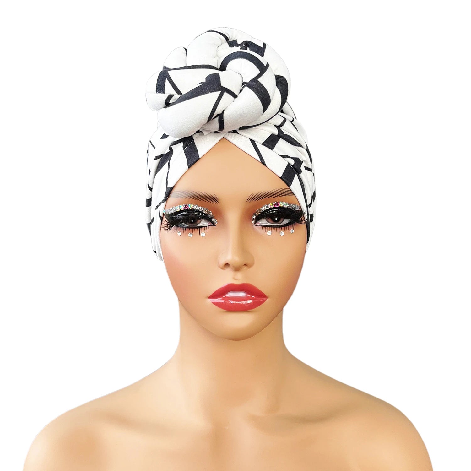 Front view of a stylish patterned knot turban headwrap in black and white geometric design, displayed on a mannequin. Elegant and trendy headwear.