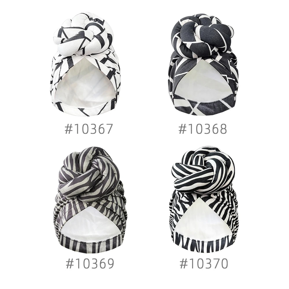 Four variations of stylish patterned knot turban headwraps with unique black and white prints. Elegant and versatile headwear for any occasion.