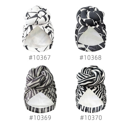 Four variations of stylish patterned knot turban headwraps with unique black and white prints. Elegant and versatile headwear for any occasion.