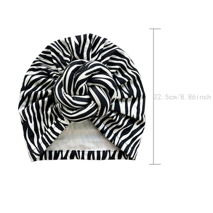 Black and white zebra-striped patterned knot turban headwrap with dimensions of 22.5 cm. Stylish and comfortable headwear for various occasions.