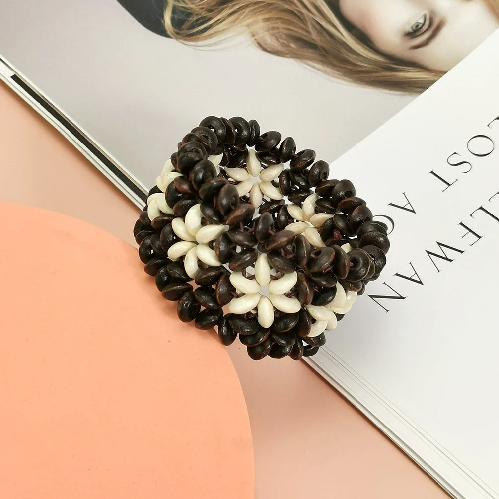 Wooden Bead with White Flower Bracelet – Elastic Cuff Bangle for Women on a magazine