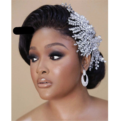 Bride wearing sparkling crystal tiara styled to the side with voluminous waves