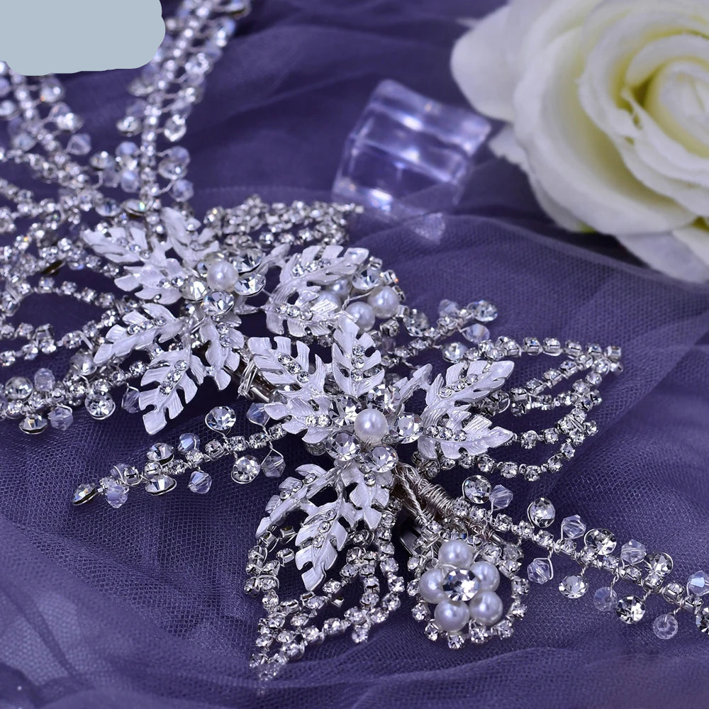 Close-up of silver bridal hairpiece with pearl flowers and crystal leaf detailing