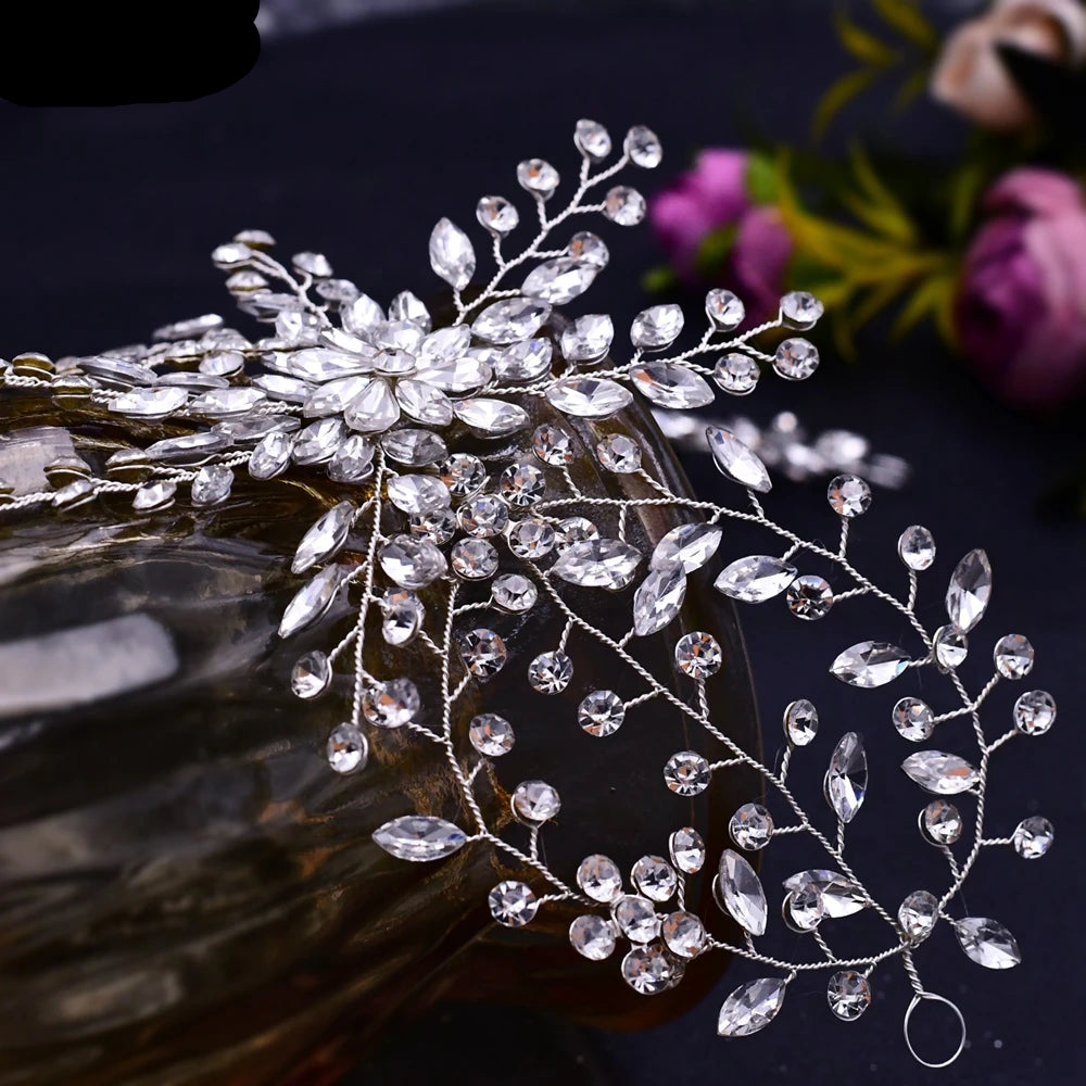 Close-up of floral crystal bridal tiara with delicate silver vines and sparkling rhinestones