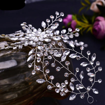 Close-up of floral crystal bridal tiara with delicate silver vines and sparkling rhinestones