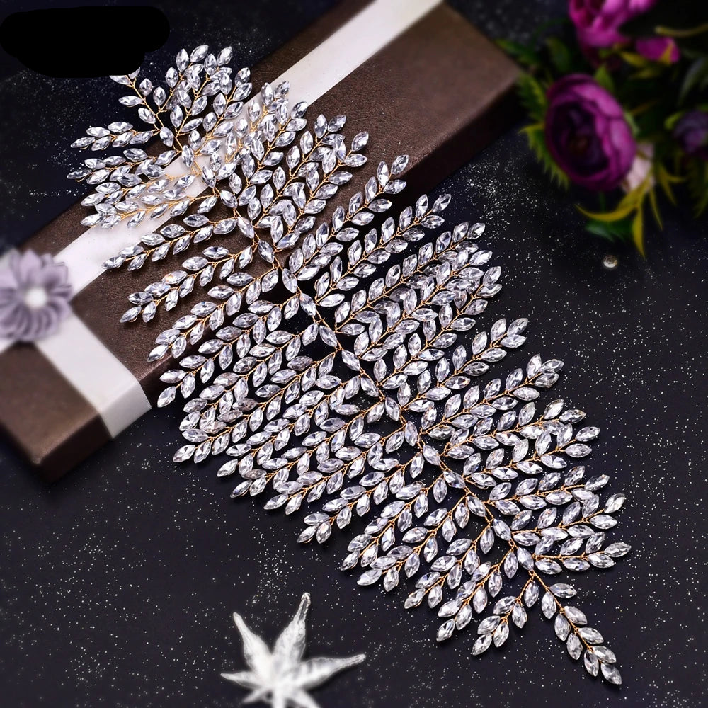 Crystal bridal tiara displayed on brown box with leaf pattern details and sparkling rhinestones