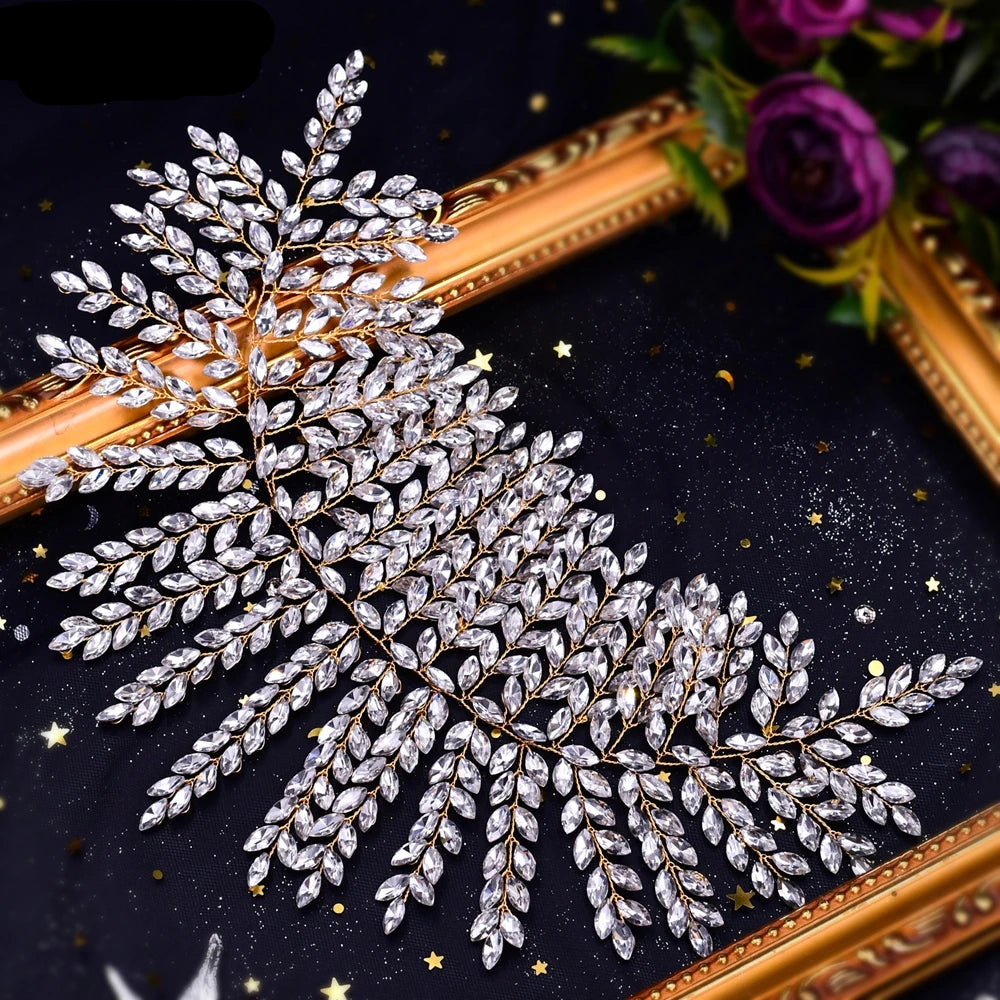 Close-up of bridal crown tiara with gold base and clear crystal leaves