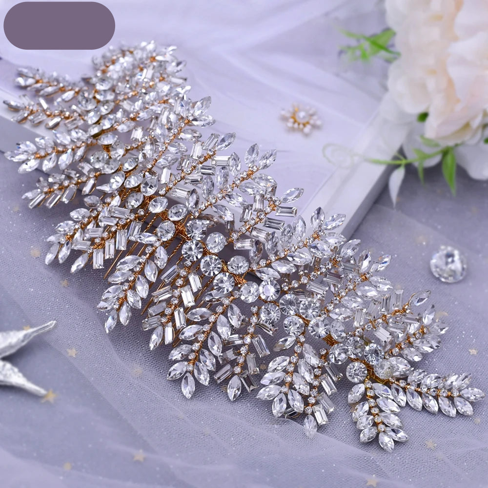 Elegant gold leaf bridal hairpiece displayed flat with floral decor in the background