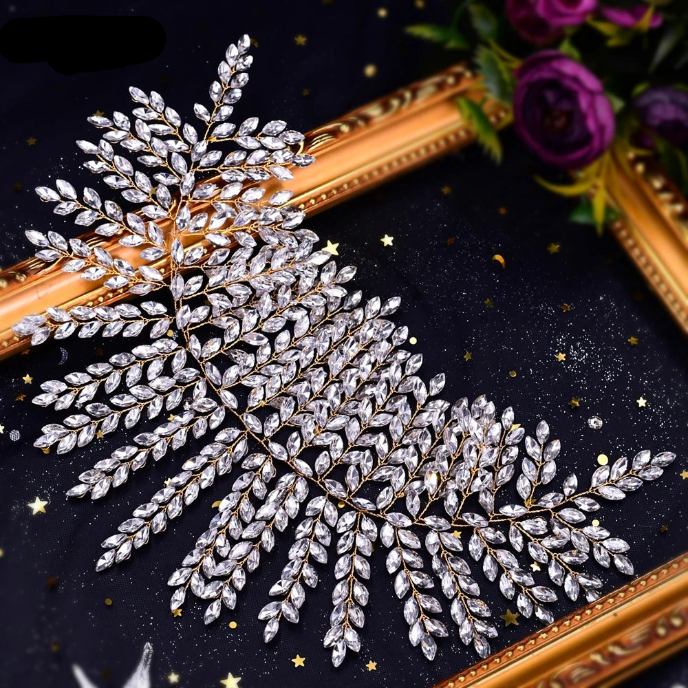 Gold base bridal tiara with shimmering leaf motif crystals displayed on starry background