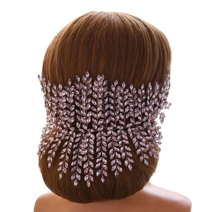 Bride wearing pink leaf bridal tiara styled at the back of an elegant updo