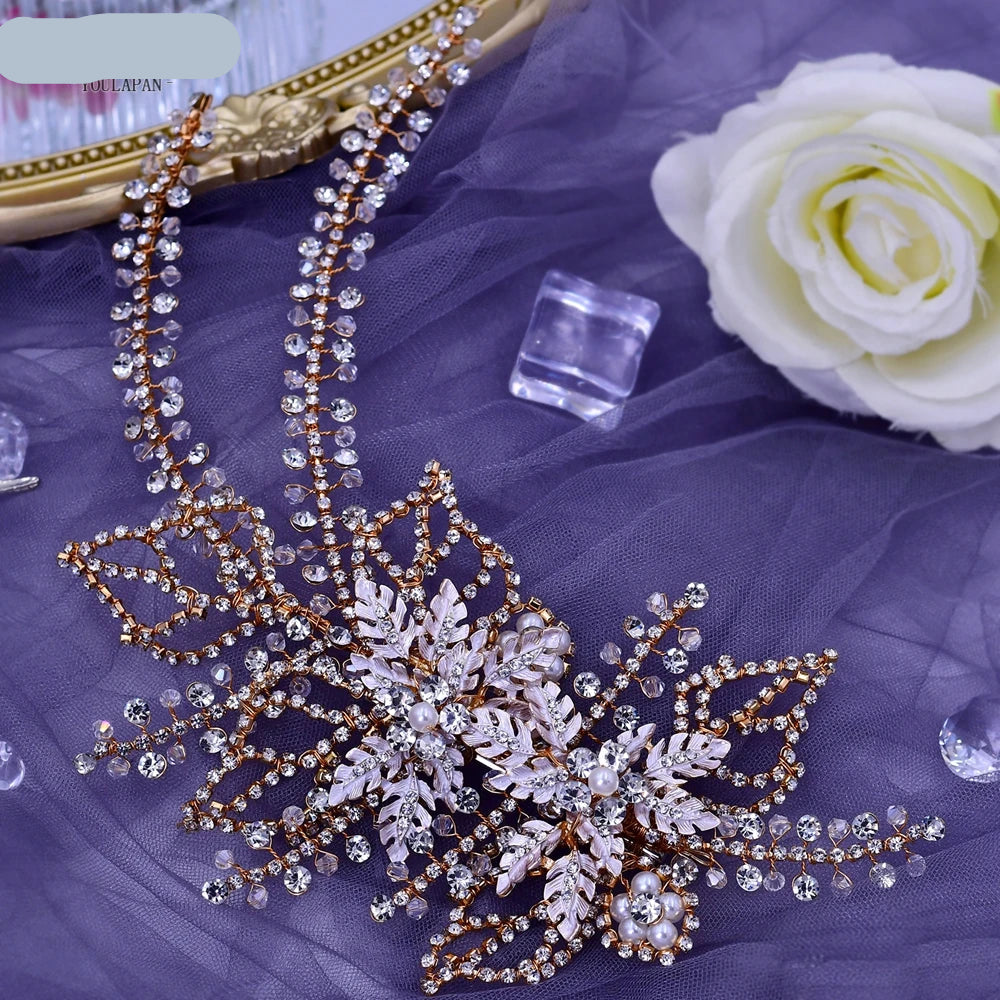 Rose gold floral bridal headpiece with sparkling crystal strands and leaf design displayed flat on fabric
