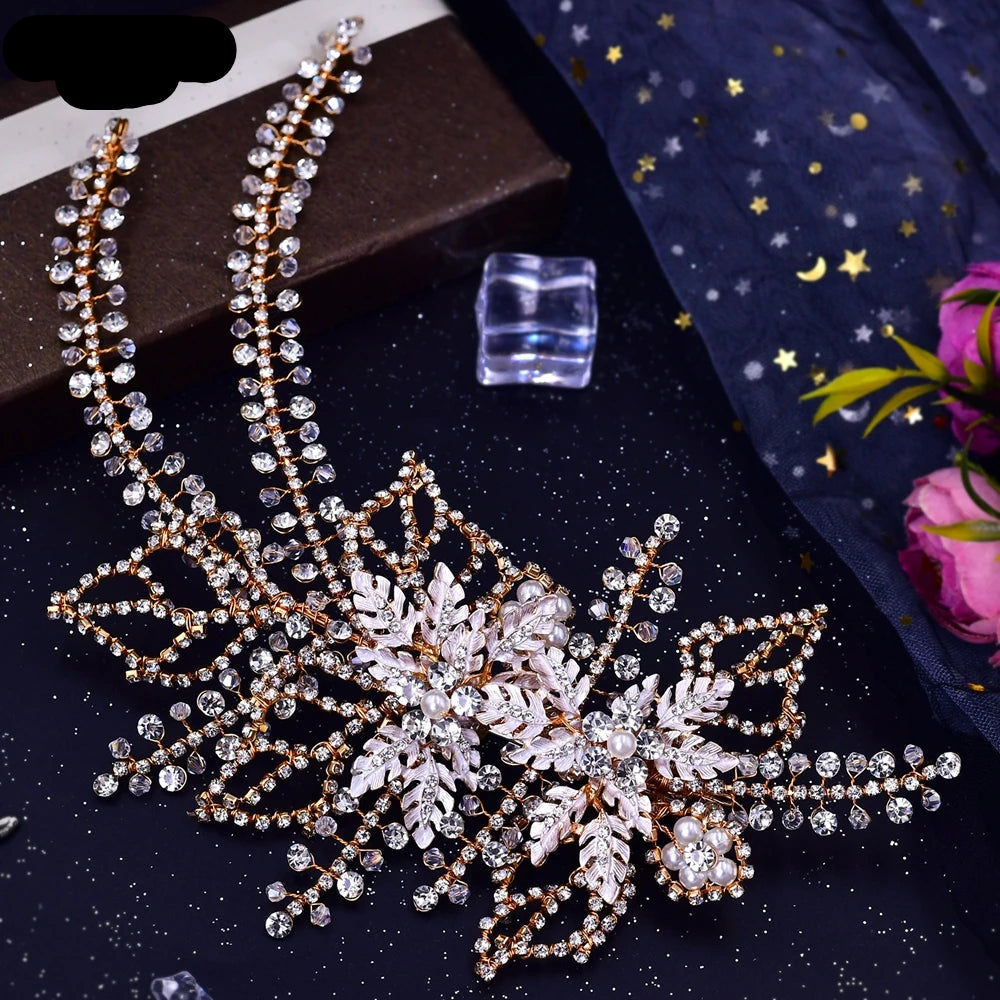 Rose gold bridal hairpiece with floral leaves, pearls and crystal detailing displayed on black background with star accents
