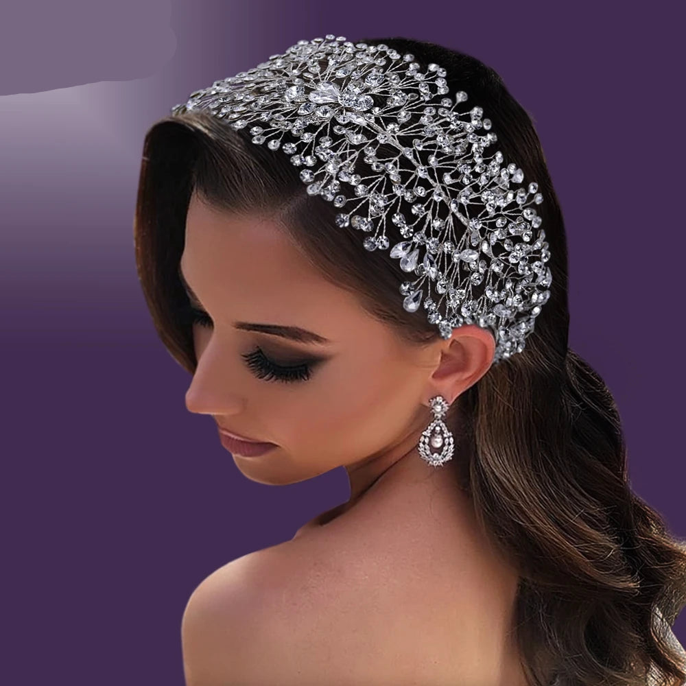 Bride wearing wide silver crystal tiara styled with soft waves for a glamorous bridal hairstyle
