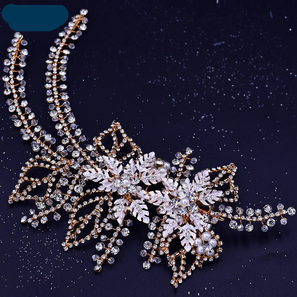 Gold bridal headpiece with pearl and crystal leaf accents on a dark starry background