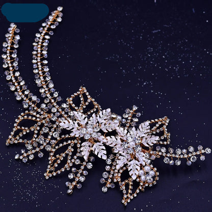 Gold bridal headpiece with pearl and crystal leaf accents on a dark starry background