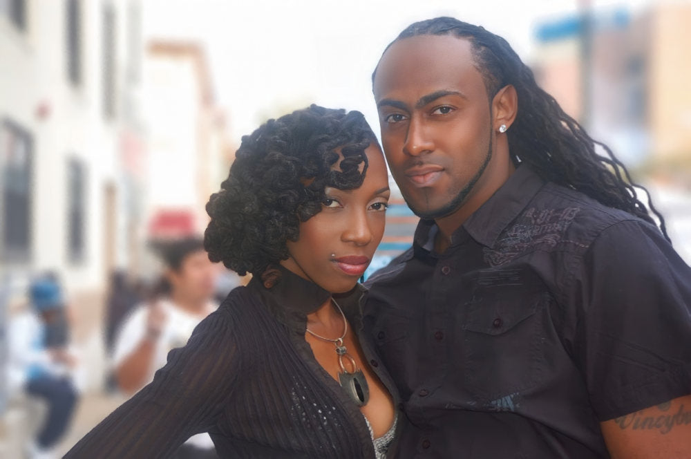 Locs styled a couple. Woman with curled styled Dreadlocks and a Man with long locs crinkled.