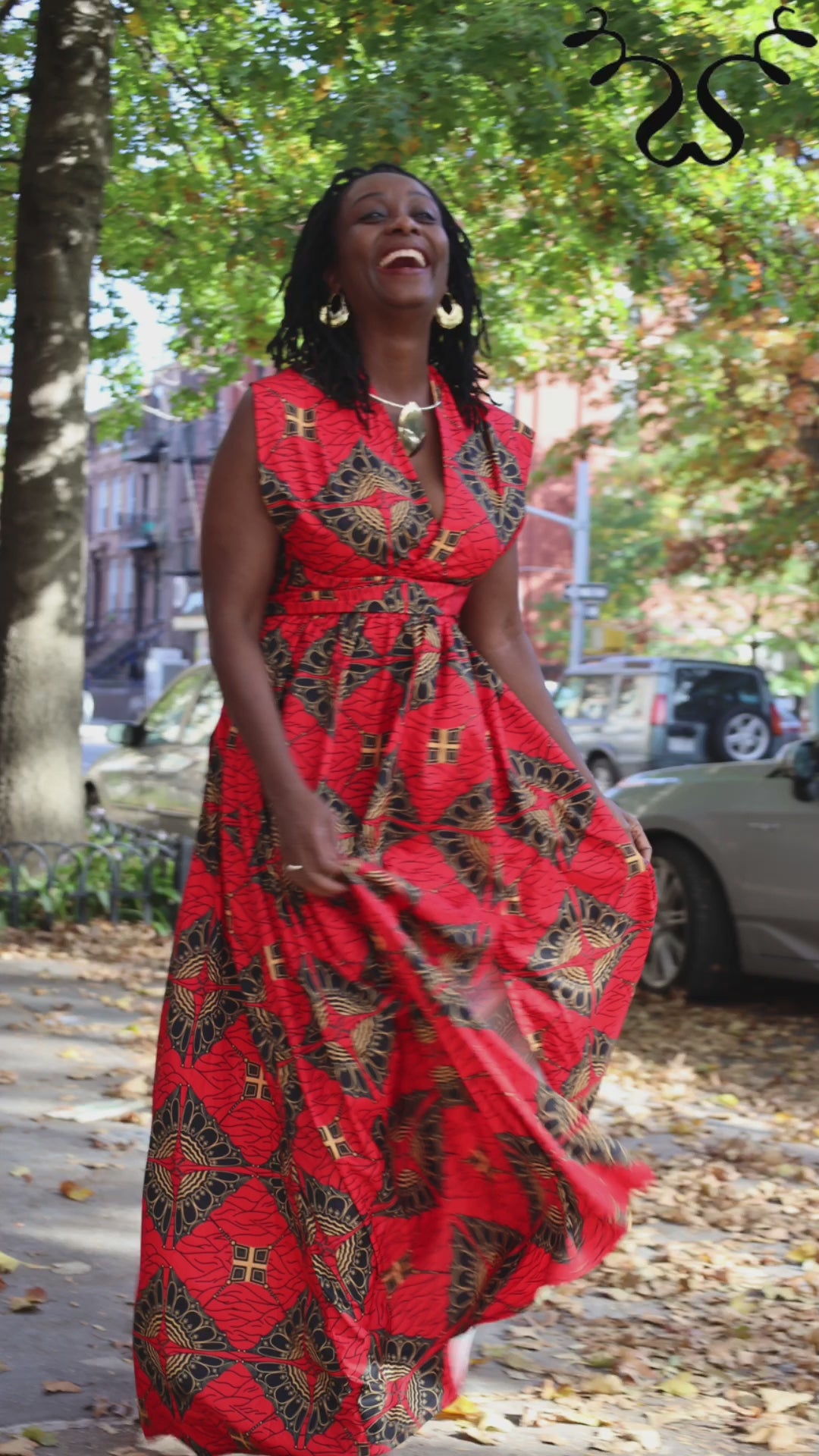 Elegant Infinity Maxi Dress in vibrant red Ankara African print, featuring a flowing silhouette and versatile wrap design for multiple styling options.