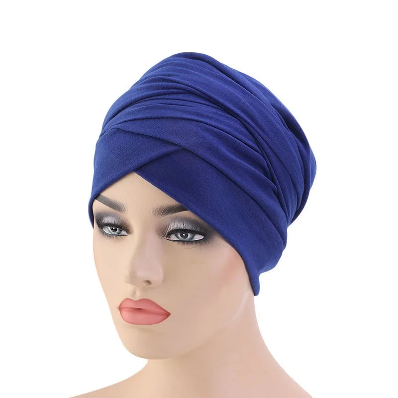 A royal blue knotted headwrap turban hat displayed on a female mannequin head against a plain white background.
